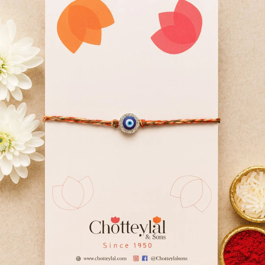 Nazariya Grace – Silver Rakhi with Colorful Stone Thread