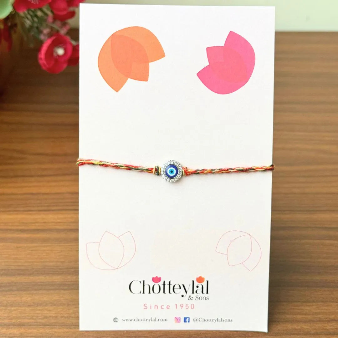 Nazariya Grace – Silver Rakhi with Colorful Stone Thread
