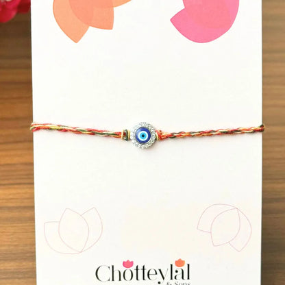 Nazariya Grace – Silver Rakhi with Colorful Stone Thread