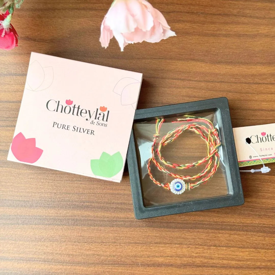 Nazariya Grace – Silver Rakhi with Colorful Stone Thread